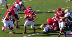 Montclair State football team executing a running play