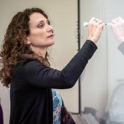 instructor writing on whiteboard