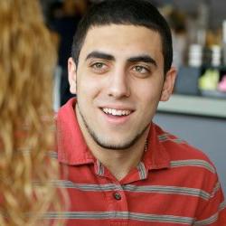 Young man with brown hair smiling