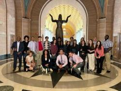 students stand in group photo in front of statue in a rotunda at NJ Federal Court House