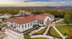 aerial view of Cole Hall at dusk. NYC skyline can be seen in background