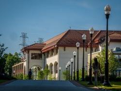 A student walking by the School of Communication and Media and Life Hall.