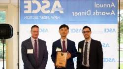 Dr. Yang Deng receiving the Educator of the Year award from ASCE-NJ