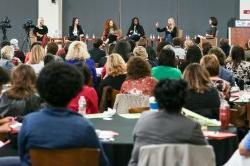 Audience watching panel of women