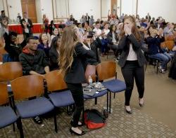 Two women look shocked, reacting to winning pitch contest.