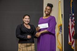 Alicia-Ann Caesar receiving award from Olivia Hettman