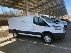 Photo of the driver's side of the new electric van #269 parked in lot 61 under the solar panels.