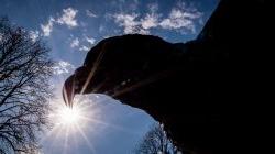 Image of the hawk statue from below on a sunny day