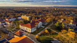 aerial view of campus at sunset with NYC skyline in background