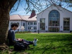 Student sitting outside Cole Hall