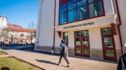 Student walking past the entrance of the Center for Computing and Information Science