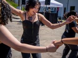 Students dance in a round.