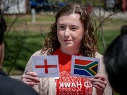 Student holds two world flags.