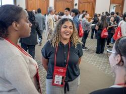 A recent graduate is seen speaking with other students