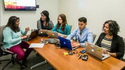 green team brainstorming in conference room