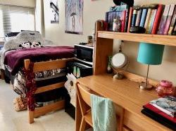 Another side of a double room in Blanton Hall with a bed and desk decorated by a student.