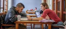 Picture of two students looking at a document.