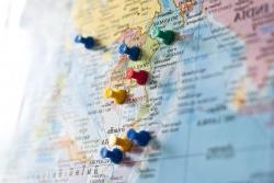 Photo of map with colorful pins marking Southeast Asia countries.