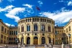 The Storting building, the Norwegian parliament in Oslo with flag.