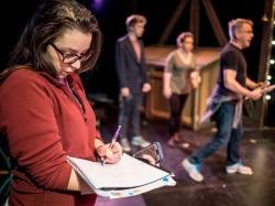 Students and Faculty discussing theatre set