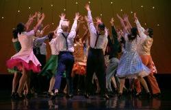 Photo of students dancing on stage to promote Spring Dance 2023